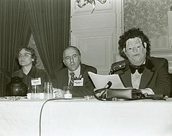 The famous Gay debate at the American Psychiatric Association in 1972: Barbara Gittings, Frank Kameny and a Gay psychiatrist (John E. Fryer) in a Halloween mask. 